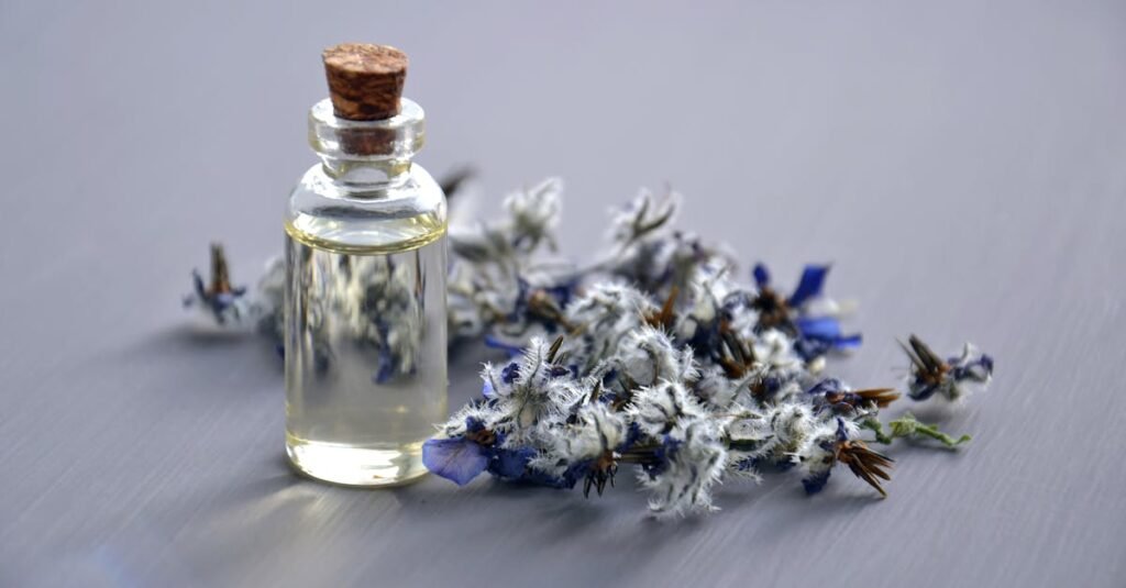 Close-up of a lavender oil bottle with dried flowers for aromatherapy. Perfect for wellness themes.
